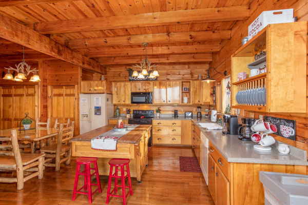 Large kitchen with bar stools at The Original American Dream, a 2 bedroom cabin rental located in Gatlinburg