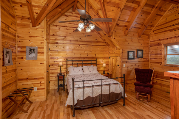 Bedroom with a bed, night stands, and lamps at Majestic Views, a 3 bedroom cabin rental located in Pigeon Forge