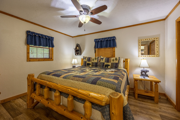 Log king bed at Cabin On The Hill, a 1 bedroom cabin rental located in Pigeon Forge