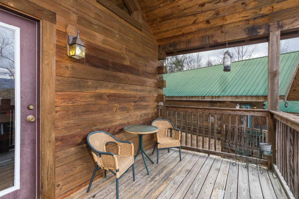 Bistro set on a covered deck at Precious View, a 1 bedroom cabin rental located in Gatlinburg