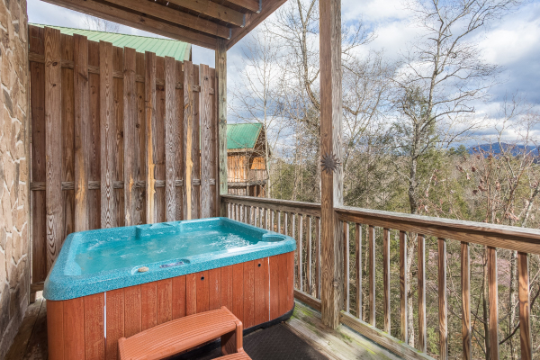 Hot tub on a covered deck with privacy fence at Precious View, a 1 bedroom cabin rental located in Gatlinburg