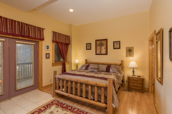 King log bed on the first floor at Precious View, a 1 bedroom cabin rental located in Gatlinburg