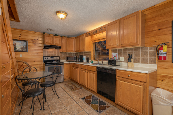 Kitchen with a small bistro set at Pine Splendor, a 5 bedroom cabin rental located in Pigeon Forge