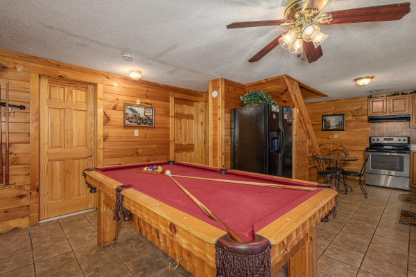 Red felt pool table at Pine Splendor, a 5 bedroom cabin rental located in Pigeon Forge