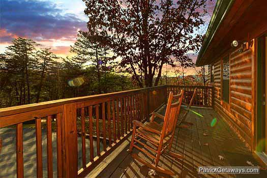 Rear deck with rocking chairs at Pine Splendor, a 5 bedroom cabin rental located in Pigeon Forge