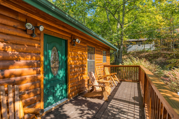 Deck with Adirondack chairs at Pine Splendor, a 5 bedroom cabin rental located in Pigeon Forge