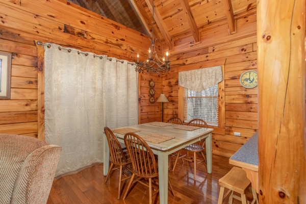 Dining table for four at The Cowboy Way, a 4 bedroom cabin rental located in Pigeon Forge