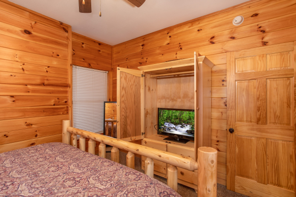 Armoire and TV in a bedroom at The Cowboy Way, a 4 bedroom cabin rental located in Pigeon Forge