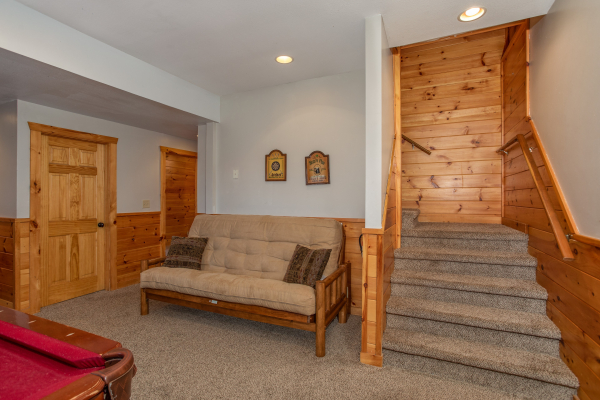 Futon in the game room at The Cowboy Way, a 4 bedroom cabin rental located in Pigeon Forge