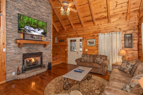 Fireplace and TV in a living room at The Cowboy Way, a 4 bedroom cabin rental located in Pigeon Forge