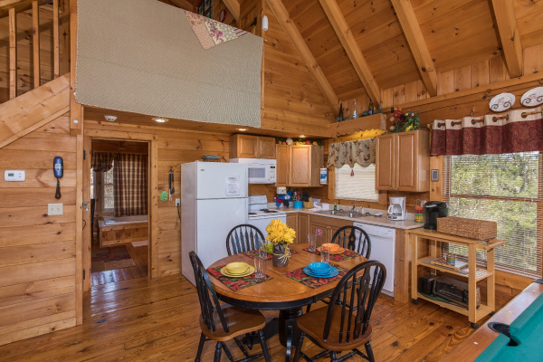 Dining room space with seating for four in the great room at Cloud 9, a 1-bedroom cabin rental located in Pigeon Forge
