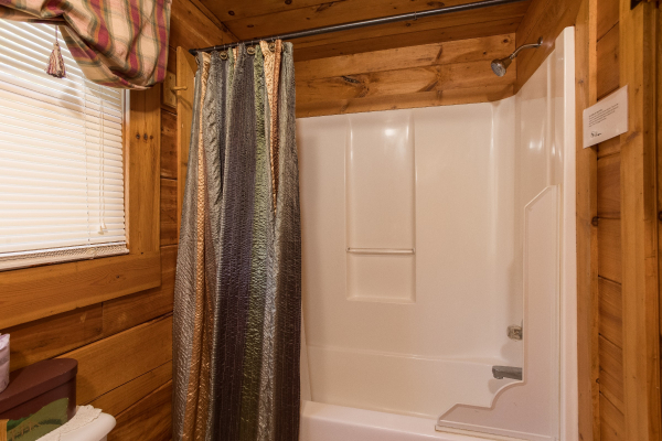 Bathroom with a tub and shower at Cloud 9, a 1-bedroom cabin rental located in Pigeon Forge