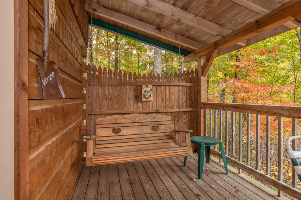 Covered porch with swing at Love Me Tender, a 1 bedroom cabin rental located in Pigeon Forge