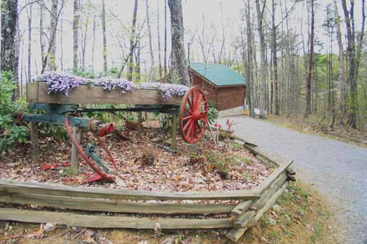Old wagon in landscape at Love Me Tender, a 1 bedroom cabin rental located in Pigeon Forge