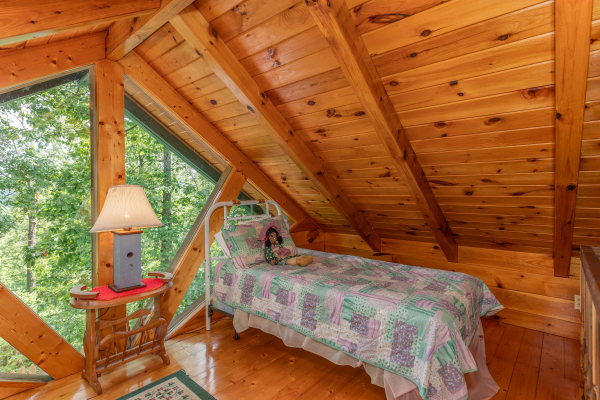 Twin bed in the loft space at Just Us, a 1 bedroom cabin rental located in Pigeon Forge