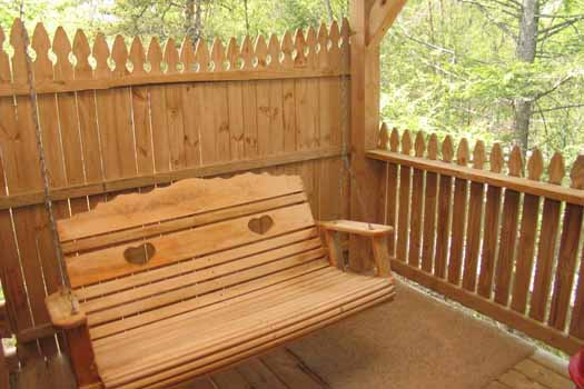 Swing on the deck at Forever Yours, a 1-bedroom cabin rental located in Pigeon Forge