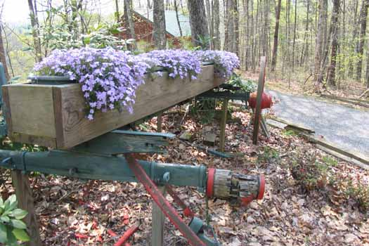 Old wagon frame in the landscape at Forever Yours, a 1-bedroom cabin rental located in Pigeon Forge