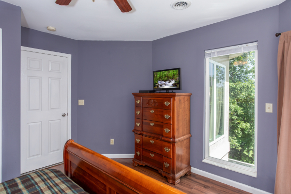 Dresser and TV in a bedroom at The Majestic, an 8 bedroom cabin rental located in Gatlinburg