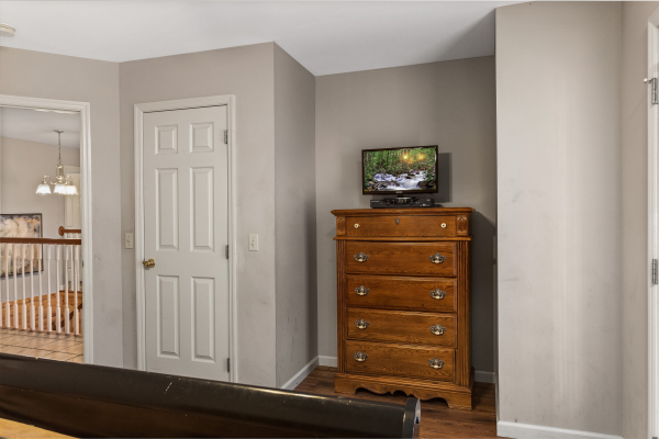 Dresser and TV in a bedroom at Chalet Mignon, an 8-bedroom cabin rental located in Gatlinburg