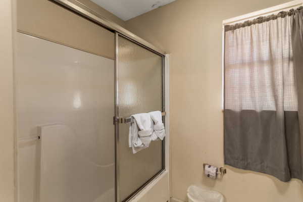 Bathroom with a tub and shower at Chalet Mignon, an 8-bedroom cabin rental located in Gatlinburg