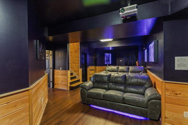 Sofas in the movie room at Chalet Mignon, an 8-bedroom cabin rental located in Gatlinburg
