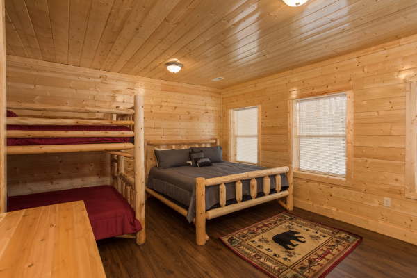 Bedroom with bunk beds and a third bed at Splash Mountain Lodge a 4 bedroom cabin rental located in Gatlinburg