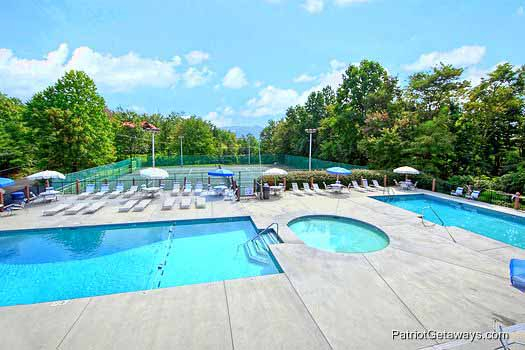 Swimming pool and tennis court at Chalet Village for guests at High Alpine #204, a 2 bedroom cabin rental located in Gatlinburg