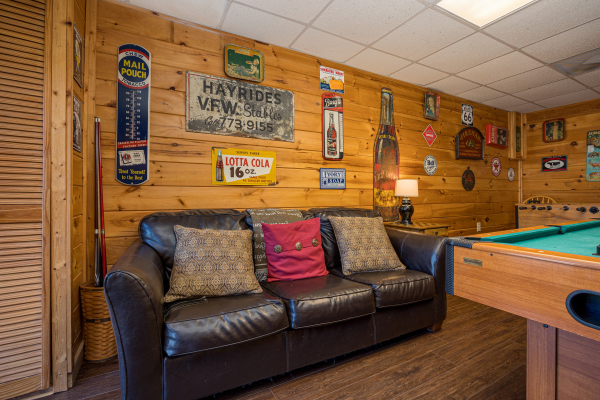 Leather couch in game room at Fox Ridge, a 3 bedroom cabin rental located in Pigeon Forge