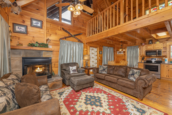Vaulted living room with a fireplace, sofa, loveseat, and chaise at Fox Ridge, a 3 bedroom cabin rental located in Pigeon Forge