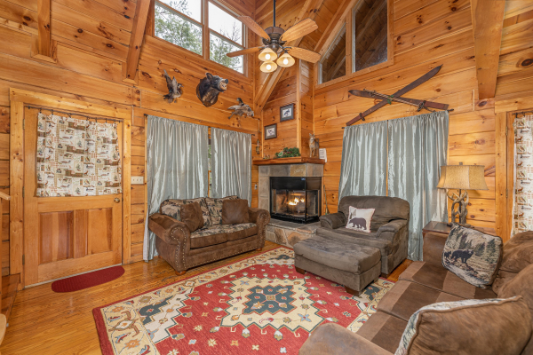 Vaulted living room with a fireplace at Fox Ridge, a 3 bedroom cabin rental located in Pigeon Forge