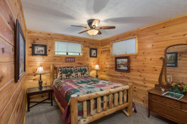 Bedroom with a log bed, two lamps, and dresser at Bird's Eye View, a 2-bedroom cabin rental located in Gatlinburg