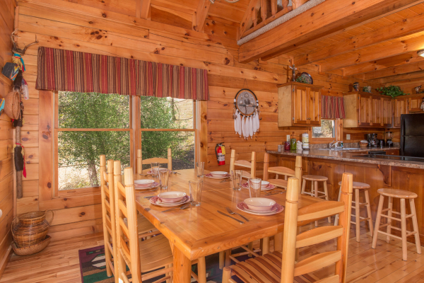 Dining table with seating for six at Alpine Sondance, a 2 bedroom cabin rental located in Pigeon Forge