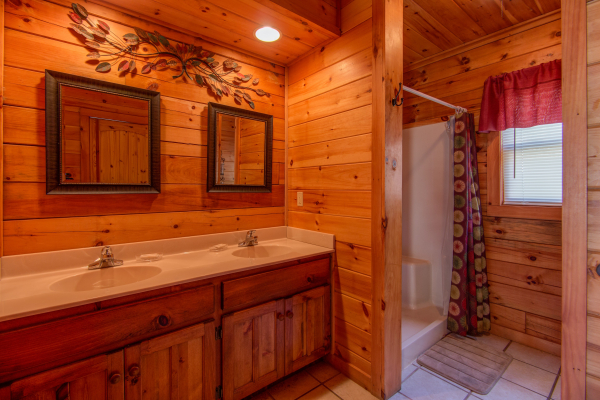 Bathroom with a double vanity and shower at Alpine Sondance, a 2 bedroom cabin rental located in Pigeon Forge