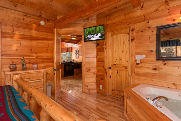 TV and jacuzzi in a bedroom at Alpine Sondance, a 2 bedroom cabin rental located in Pigeon Forge