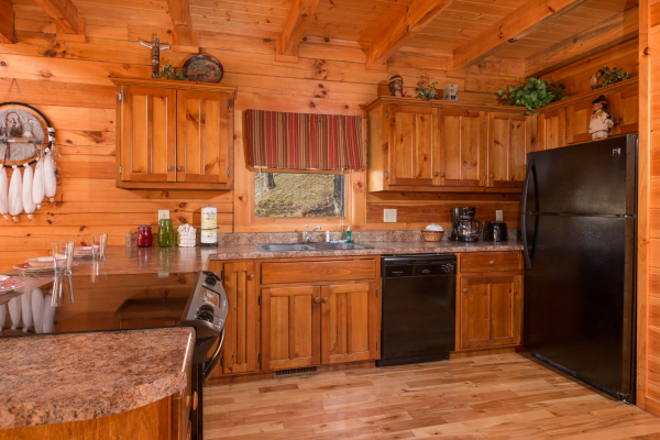 Kitchen with black appliances at Alpine Sondance, a 2 bedroom cabin rental located in Pigeon Forge