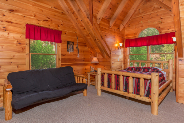 Bedroom with a log bed and futon at Alpine Sondance, a 2 bedroom cabin rental located in Pigeon Forge