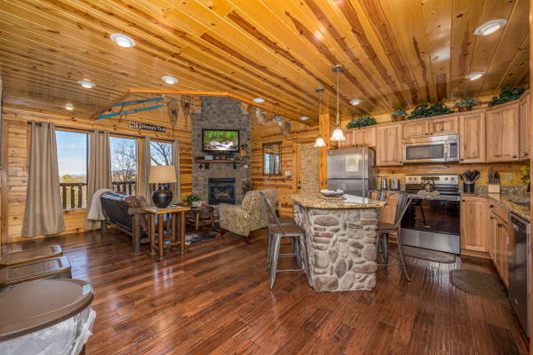 Living room and kitchen at Gone To Therapy, a 2 bedroom cabin rental located in Gatlinburg