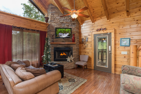 Fireplace and TV in a living room at Laid Back, a 2 bedroom cabin rental located in Pigeon Forge