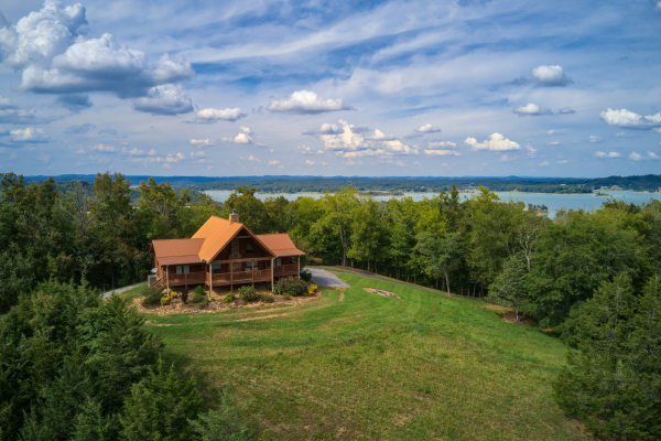 Drone exterior showing the cabin and the lake at Cedar Creeks, a 2-bedroom cabin rental located near Douglas Lake