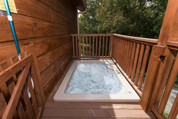 Sunken hot tub on a deck at Cedar Creeks, a 2-bedroom cabin rental located near Douglas Lake