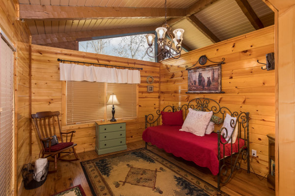 Bedroom with a daybed, dresser, and rocking chair at Rustic Ranch, a 2 bedroom cabin rental located in Pigeon Forge