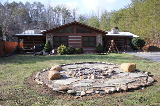 Front exterior with fire pit at Rustic Ranch, a 2 bedroom cabin rental located in Pigeon Forge
