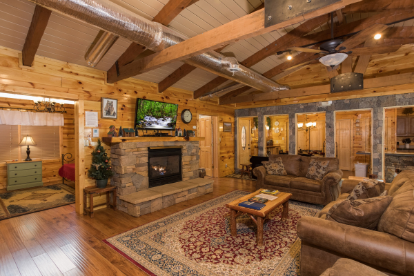 Fireplace and TV in a living room at Rustic Ranch, a 2 bedroom cabin rental located in Pigeon Forge