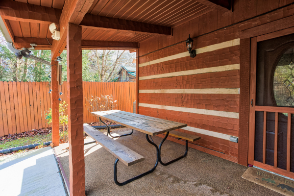 Picnic table on a patio at Rustic Ranch, a 2 bedroom cabin rental located in Pigeon Forge