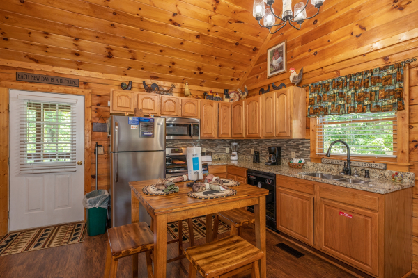 Kitchen with dining set for four at Southern Charm, a 2 bedroom cabin rental located in Pigeon Forge