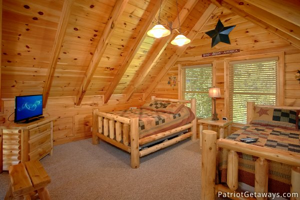Lofted bedroom with two queen beds at Alpine Sundance Trail, a 3 bedroom cabin rental located in Pigeon Forge