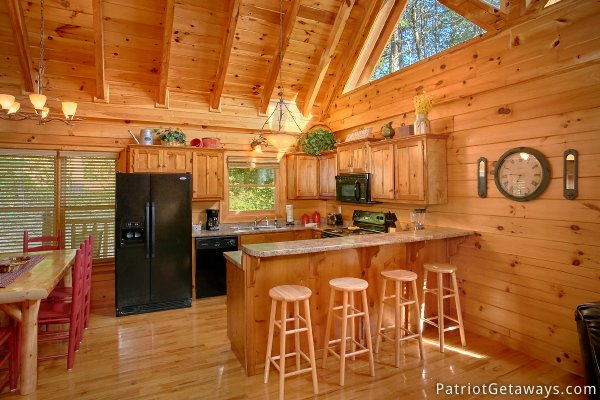 Open layout kitchen with breakfast bar at Alpine Sundance Trail, a 3 bedroom cabin rental located in Pigeon Forge