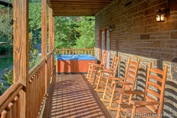Hot tub and rockers on the deck at Alpine Sundance Trail, a 3 bedroom cabin rental located in Pigeon Forge