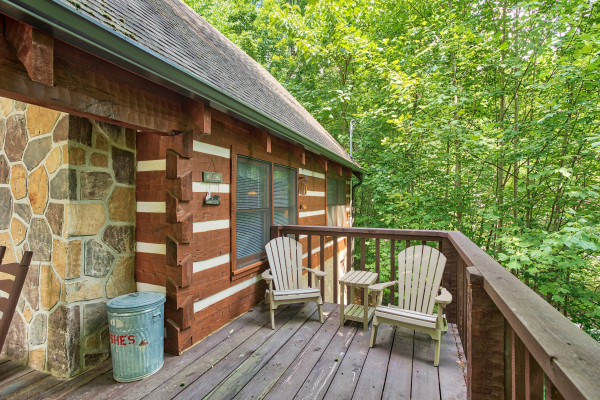 Adirondack chairs on the deck at Bearfoot Crossing, a 1-bedroom cabin rental located in Pigeon Forge