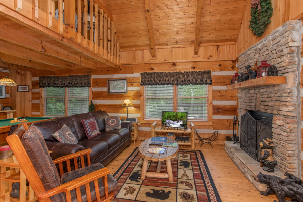 Sofa and a glider at Bearfoot Crossing, a 1-bedroom cabin rental located in Pigeon Forge